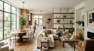 A high-end editorial shot of a bright, modern open-concept living area seamlessly divided into disti